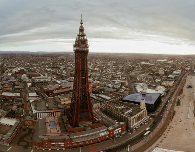 Aerial view of the iconic Blackpool Tower in England, capturing the surrounding urban landscape.