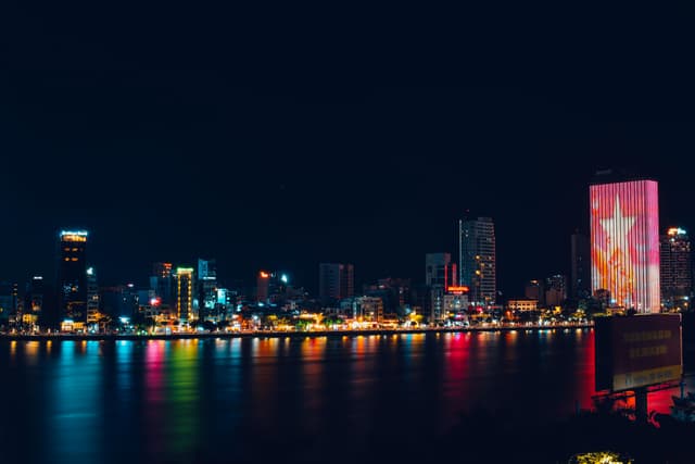 Breathtaking night scene of Da Nang skyline with city lights reflecting on the Han River.