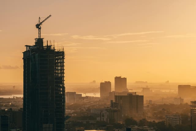 A breathtaking aerial view of Cebu City's skyline during the golden hour, showcasing urban development and high-rise buildings.