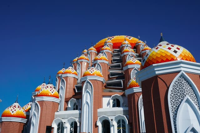 A stunning low-angle view of the 99 Domes Mosque in Makassar, showcasing intricate architectural patterns.