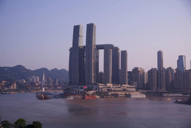 Captivating view of Raffles City and skyline by the Yangtze River in Chongqing, China.