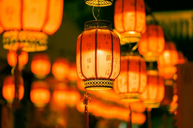 Brightly lit traditional Chinese lanterns create a warm festive atmosphere at night in Shenzhen.