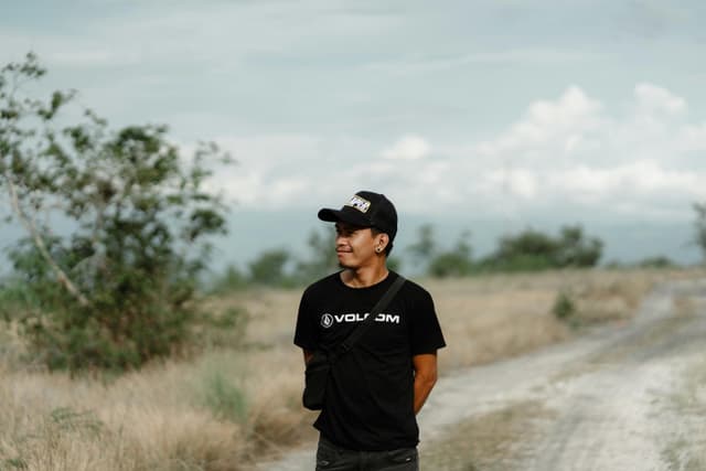 Casual portrait of a man posing outdoors on a dirt road in General Santos City, Philippines.