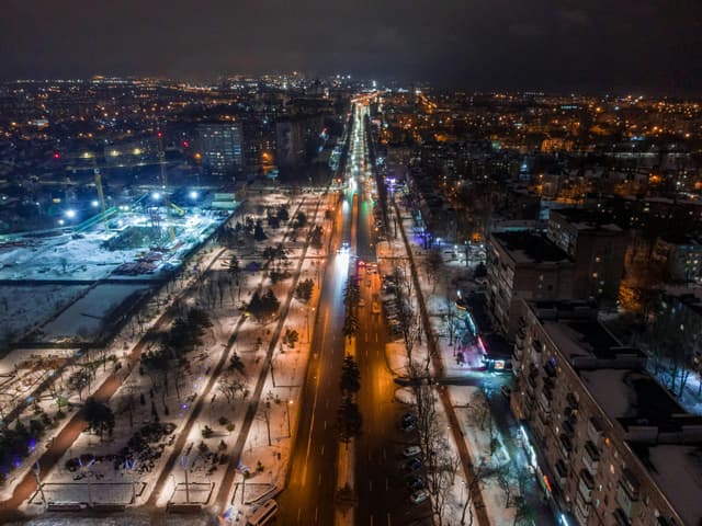 Illuminated winter cityscape of Mariupol captured at night from above.
