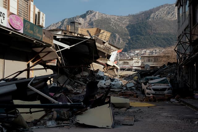 Devastating earthquake destruction in Antakya, showing collapsed buildings and debris.
