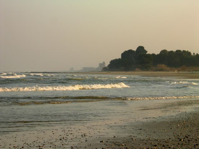 A peaceful seaside scene with gentle waves lapping the shore, perfect for a serene and tranquil mood.