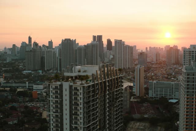 A breathtaking view of Taguig City skyline with skyscrapers at sunset.