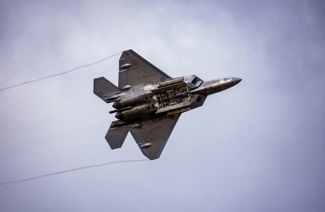 A powerful F-22 Raptor fighter jet soaring in the sky over Abilene, Texas.