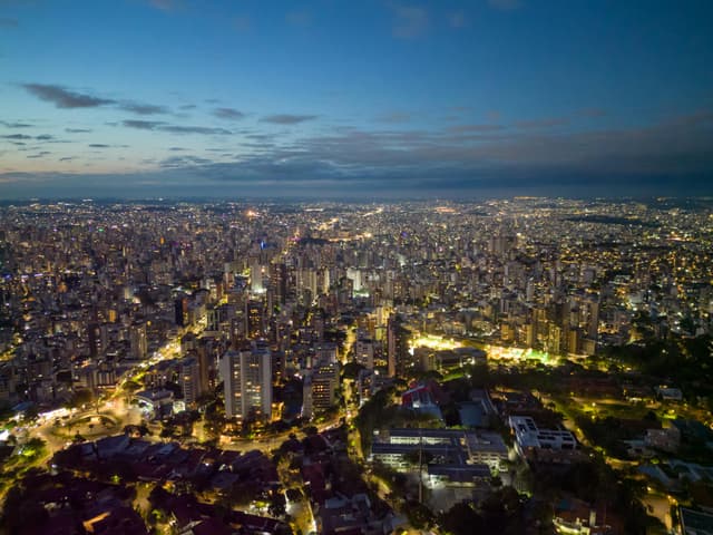 Captivating aerial cityscape of Belo Horizonte, Brazil at dusk, showcasing urban lights and skyline.