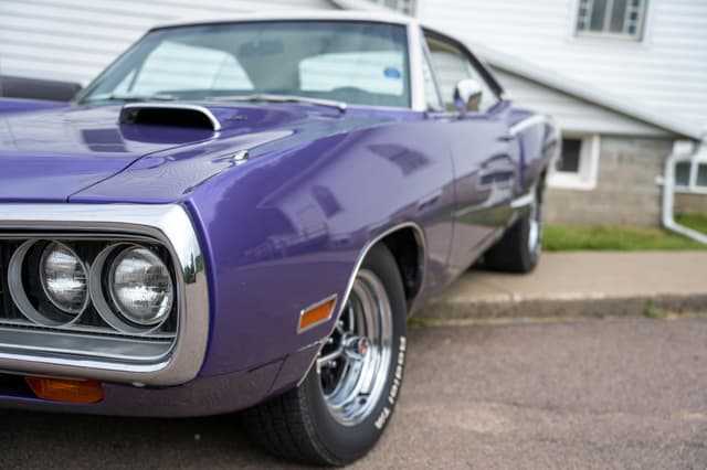Close-up of a classic purple Dodge car parked on a city street in Nelson, WI.