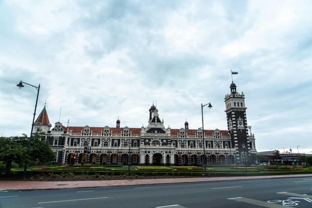 A stunning view of Dunedin Railway Station's historic architecture, captured during the day.