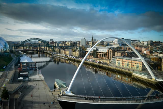 Stunning aerial view of bridges over the River Tyne in Newcastle, capturing urban architecture and vibrant skyline.