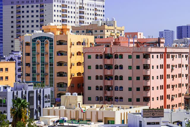 Vibrant residential apartment buildings in Ajman, UAE showcasing unique architecture and city living.