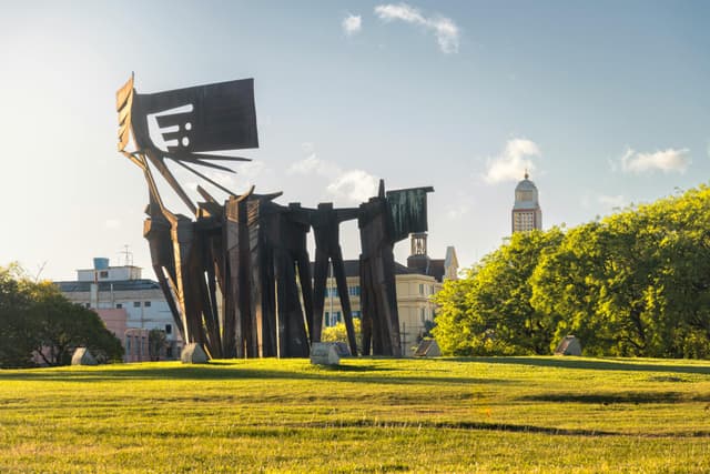 Stunning modern sculpture in Porto Alegre with city skyline backdrop.