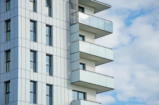 Contemporary high-rise apartment building with glass balconies in Rzeszów, Poland.