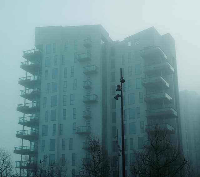 A foggy view of a modern residential building in Aalborg, Denmark.