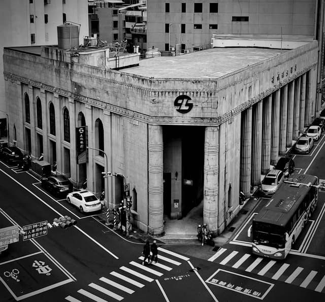 Black and white view of a historic building at a busy intersection in Tainan City, Taiwan.