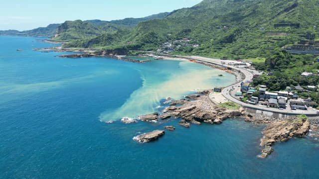 A captivating aerial shot of Taiwan's northeast coast with vibrant blue waters and lush green landscapes.