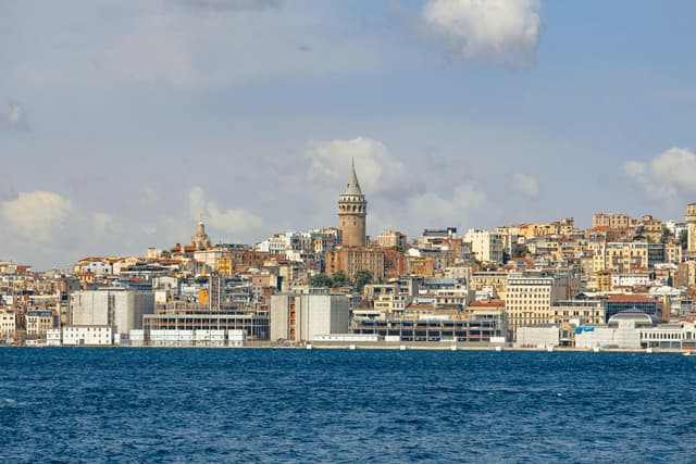 Beautiful view of the Galata Tower in Istanbul with vibrant cityscape and sea.