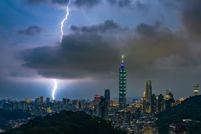 Dramatic lightning illuminates Taipei 101 during a stormy night in Taipei, Taiwan.