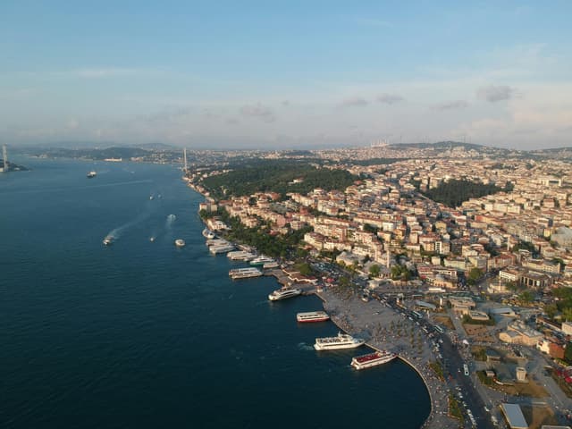 Aerial shot of Istanbul's Bosphorus coastline showcasing the vibrant cityscape and serene waters.