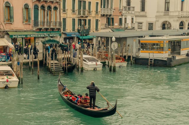 Gondola ride through the busy canals in Venice during a bright afternoon