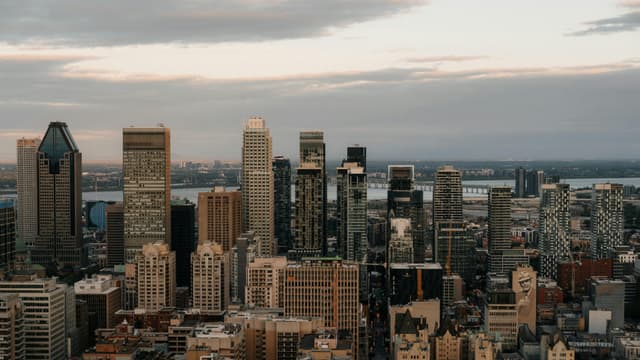 Aerial view of Montreal's downtown skyscrapers at dusk, showcasing a blend of modern architecture.