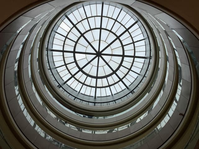 A stunning view of a modern glass dome ceiling with a geometric pattern from below.