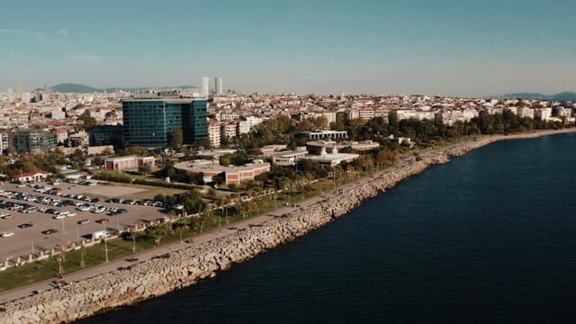 Aerial drone view of Istanbul's seaside cityscape featuring urban architecture and the Bosphorus shoreline.