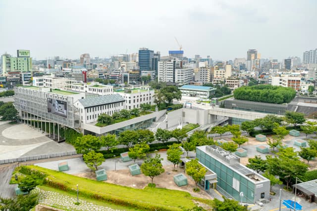 Aerial view of Gwangju cityscape showcasing modern architecture and green spaces.