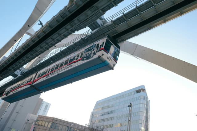 A modern monorail train passing through Chiba, Japan, showcasing urban infrastructure and transportation.