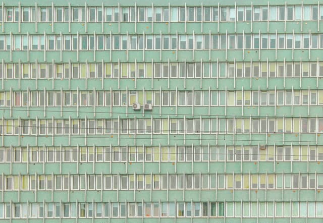 Close-up of an architectural facade with uniform windows in Kraków, Poland.