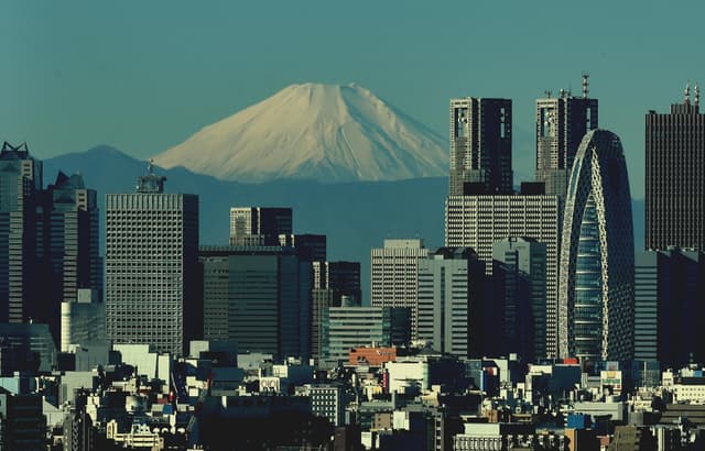 Breathtaking view of Tokyo's modern skyline with iconic Mount Fuji in the distance.