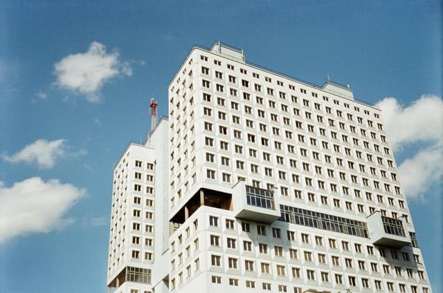 Low-angle shot of a modern building in Kaliningrad, Russia with a blue sky backdrop.